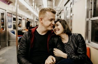 woman hugging man while sitting inside train